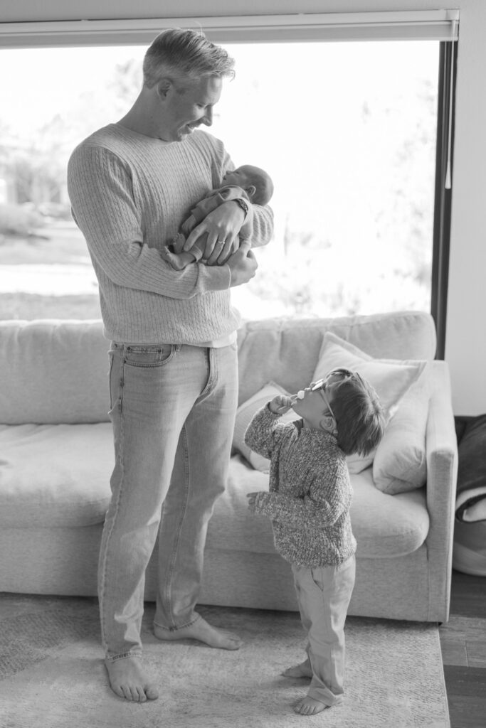 Lifestyle newborn photography session at home in Alameda, California with parents and their children