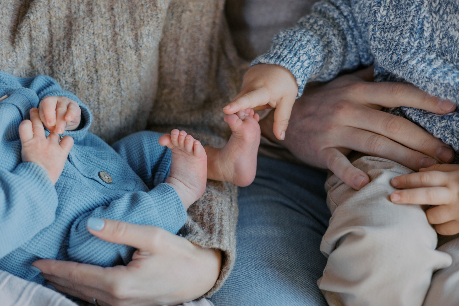 Big brother counting baby toes. Natural light newborn photography session at home in Alameda, California