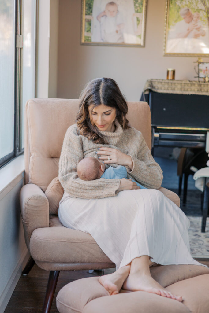 Mother holding her newborn baby during an in-home photography session in Alameda CA