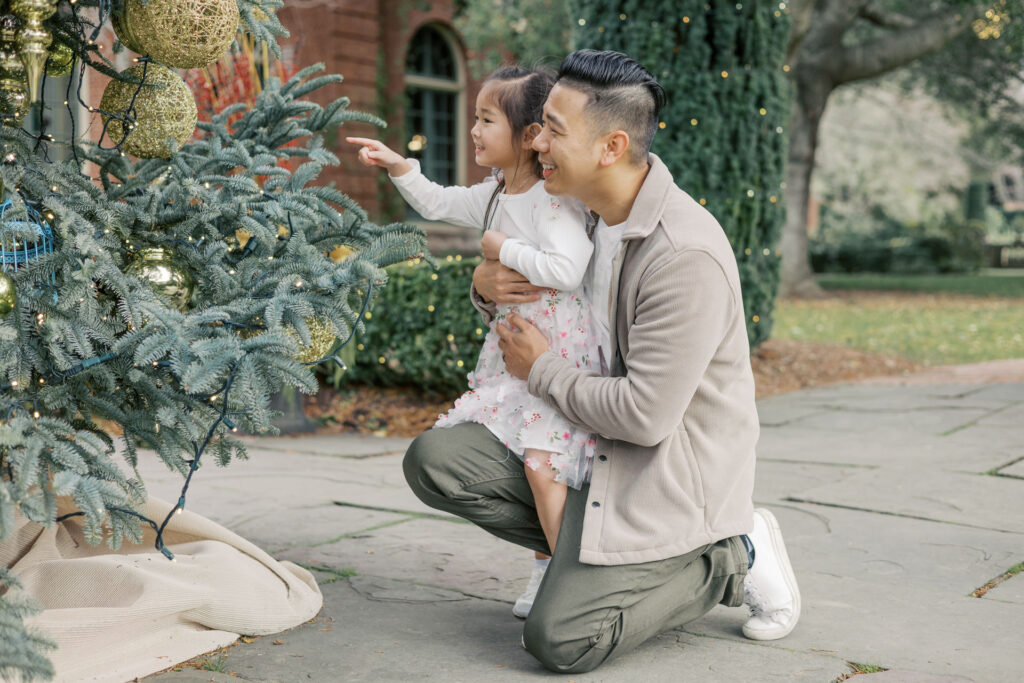 dad and daughter look at christmas tree at Filoli in Woodside during maternity photography session