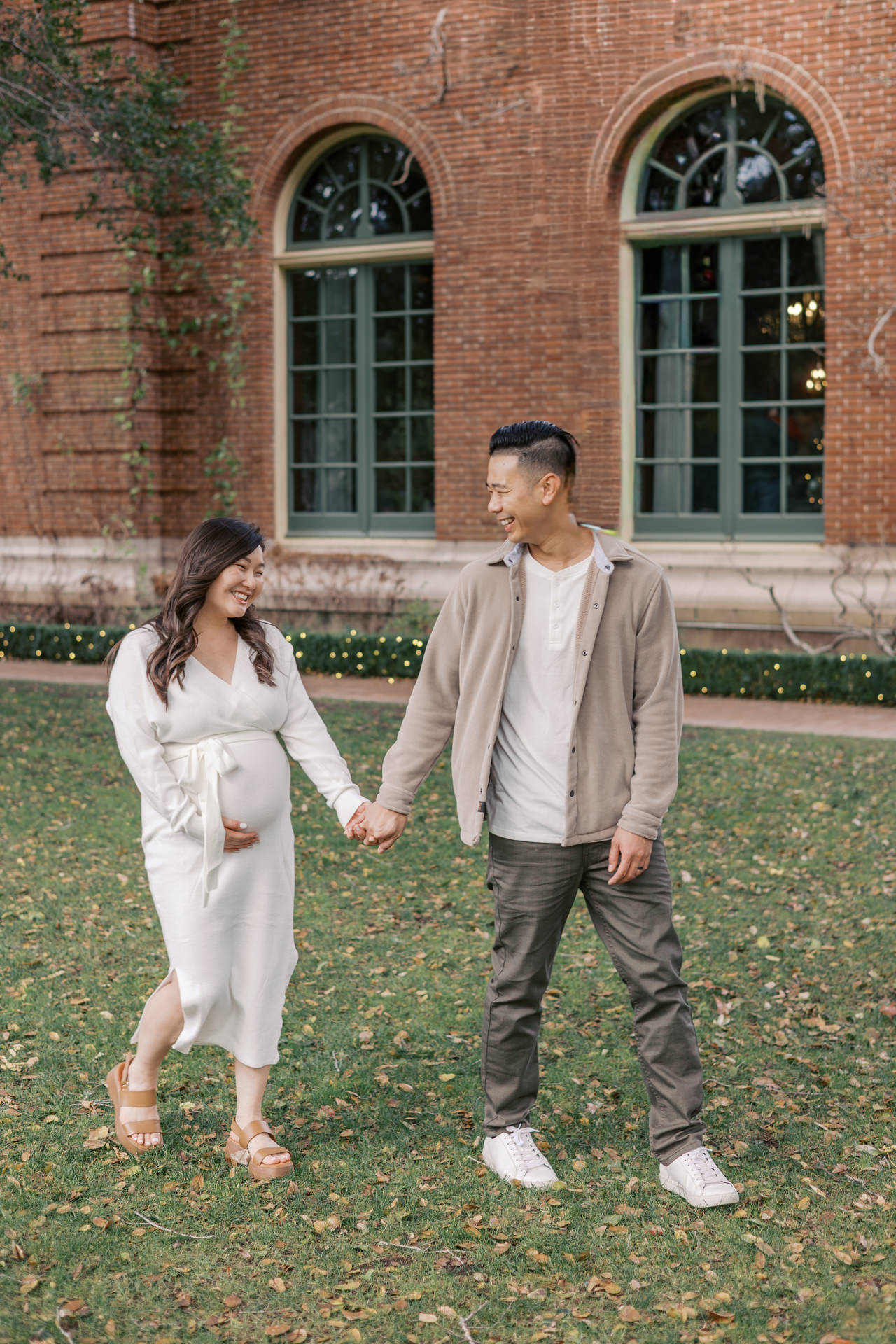 couple walks thru Filoli Gardens in Woodside during maternity photography session