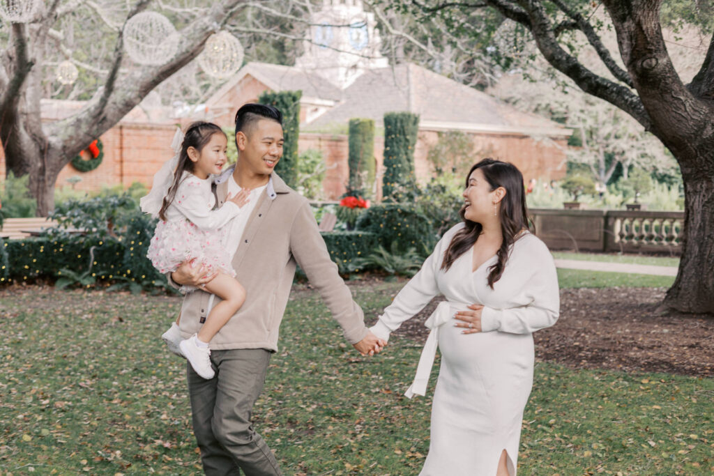 family walks thru Filoli smiling at each other during bay area family and maternity session