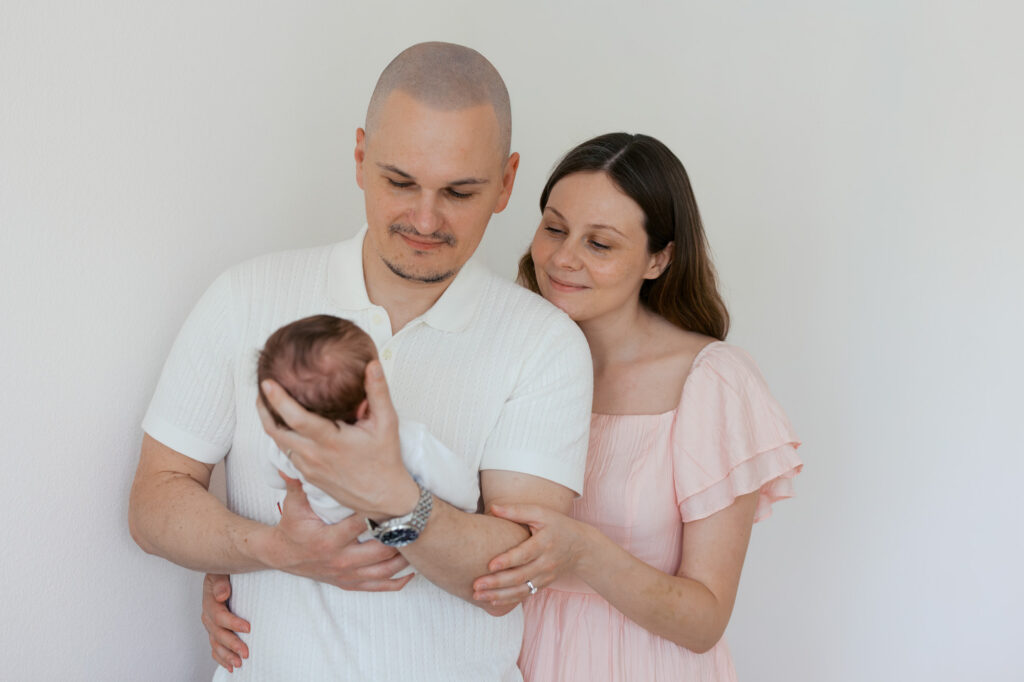 new parents gaze at newborn baby girl during their San Francisco newborn photography session