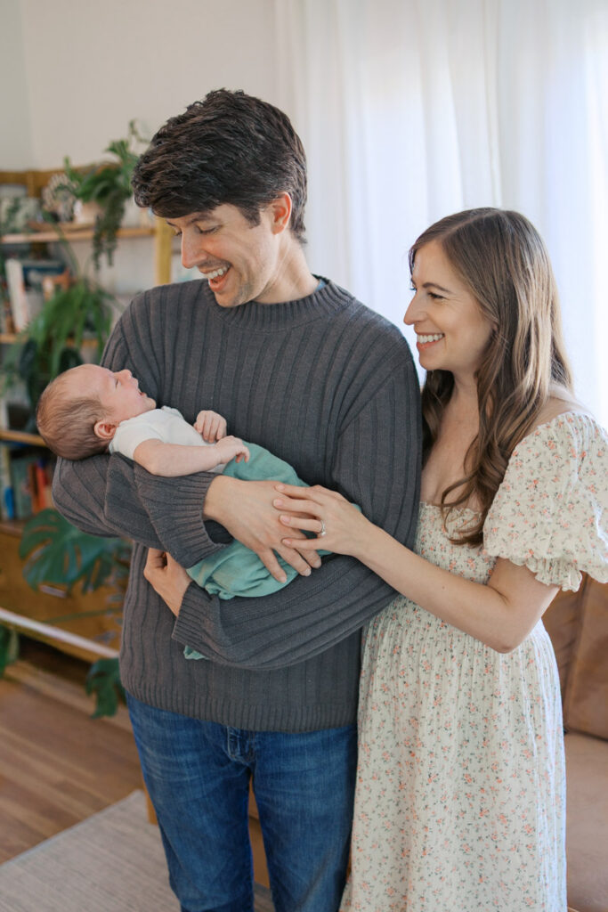 Family gazes at newborn during San Francisco Bay Area newborn photography session