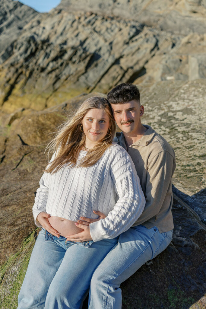 Golden Gate Bridge maternity photos with coastal cliffs at Baker Beach