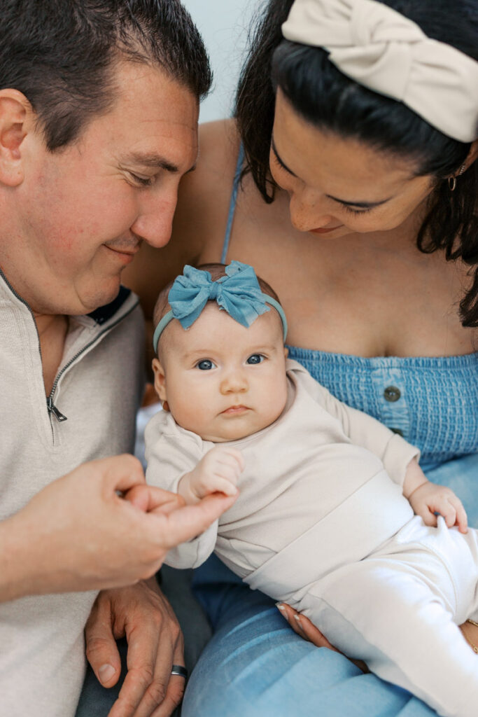 Parents holding their two month old baby during lifestyle newborn photography session in the Bay Area