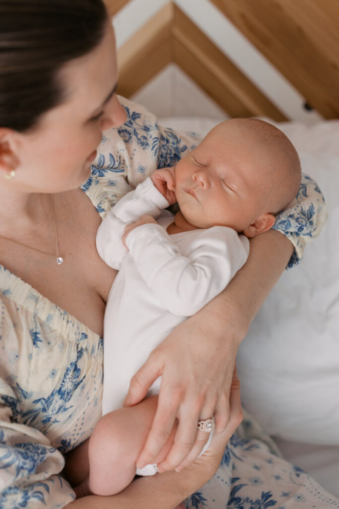 mom holds sleeping newborn during bay area newborn photography session