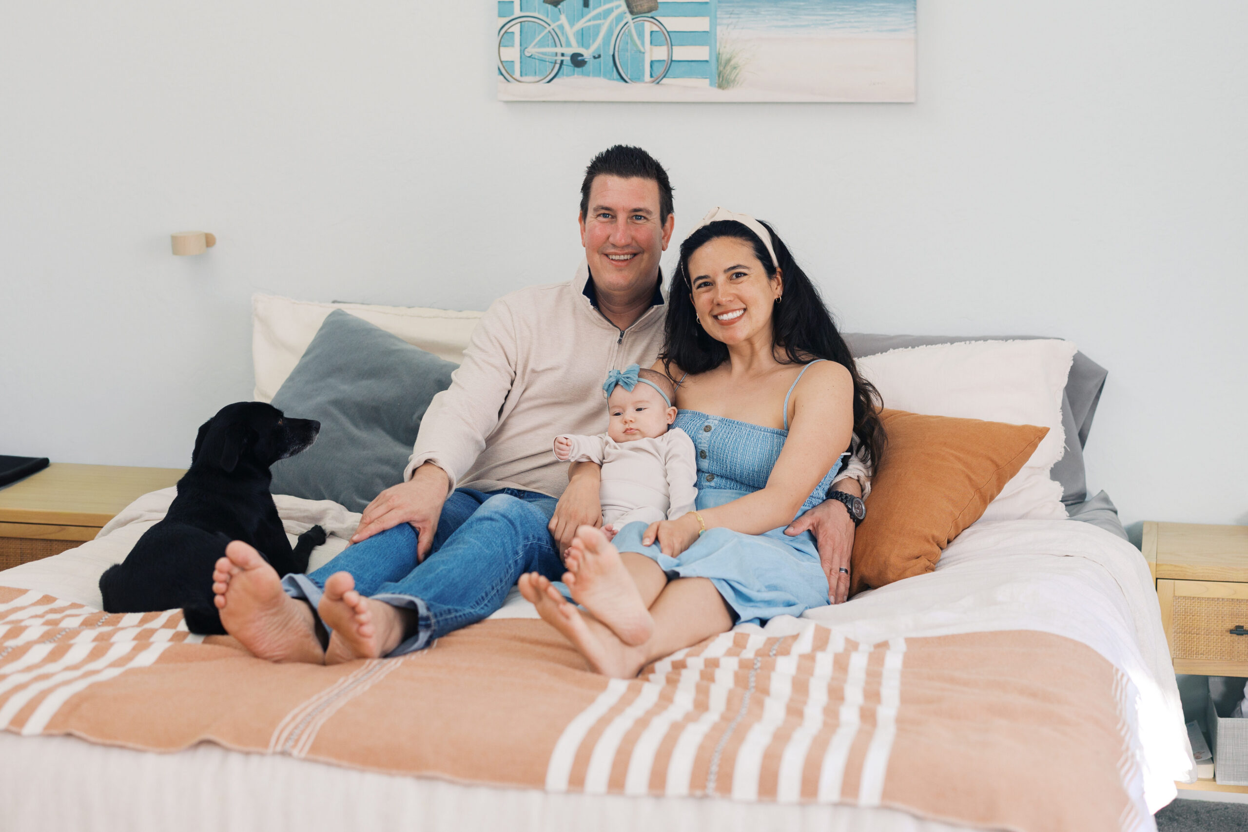 Parents holding their two month old baby during lifestyle newborn photography session in the Bay Area