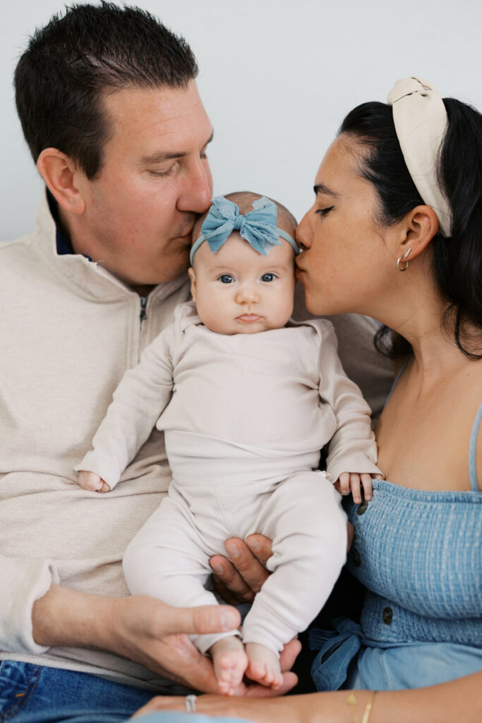 Parents holding their two month old baby during lifestyle newborn photography session in the Bay Area