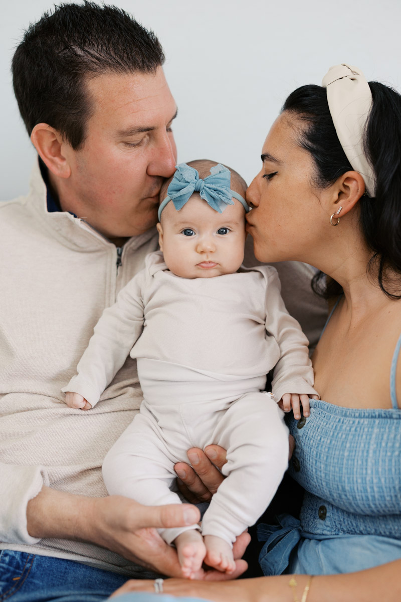 Parents holding their two month old baby during lifestyle newborn photography session in the Bay Area