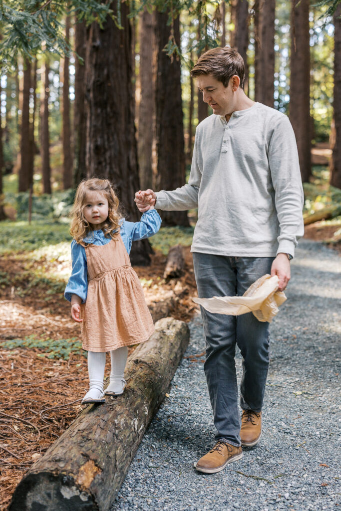 dad and 2 year old toddler play in the redwood grove during Berkeley family photography session
