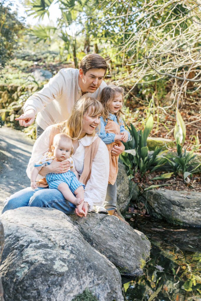 family of four explore the Japanese Pool at the Berkeley Botanical Garden during Berkeley family photography session