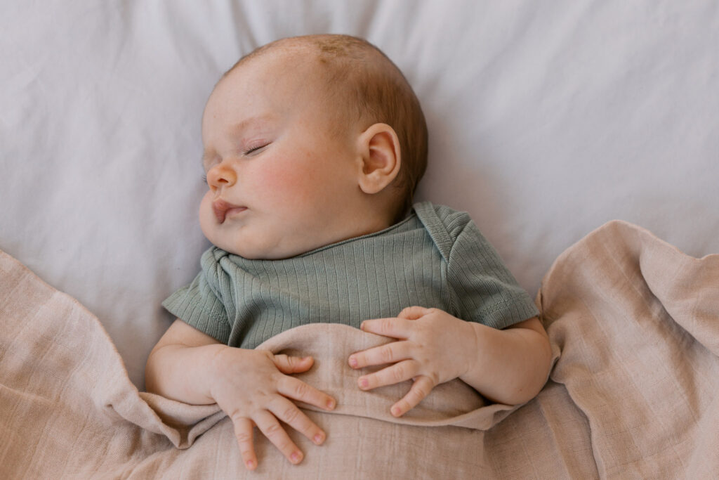2 month old sleeps on bed during San Francisco newborn photography session