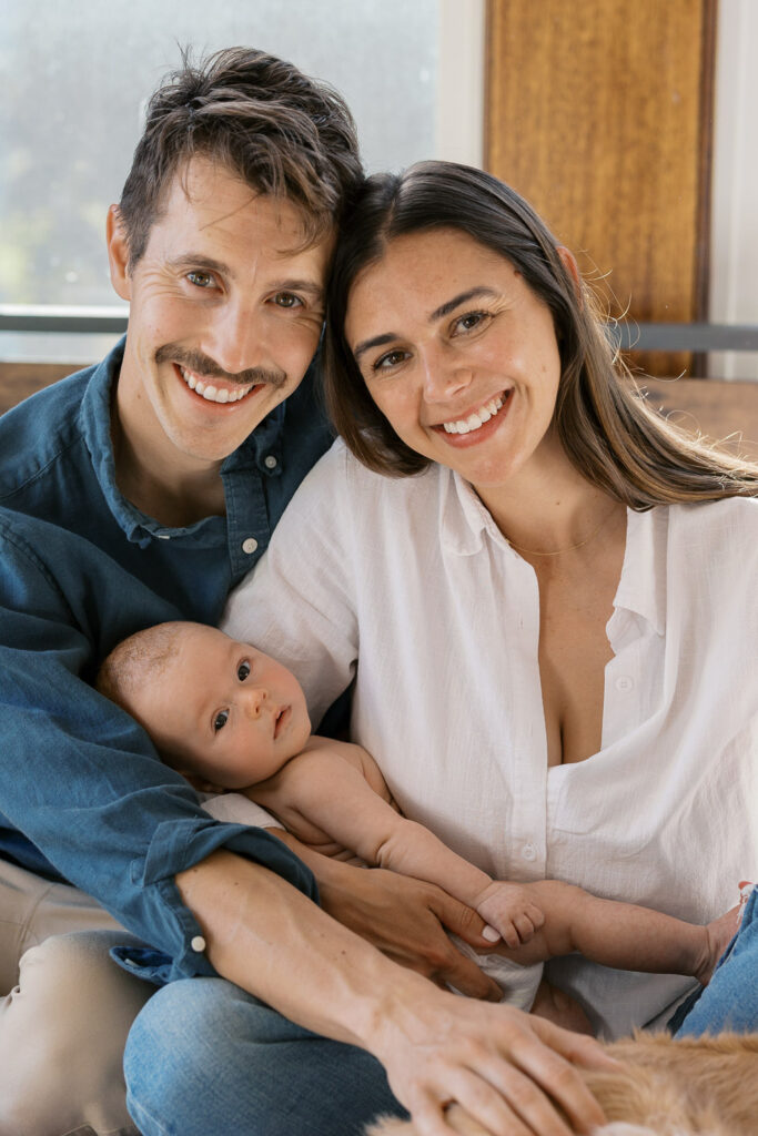 new parents hold awake older newborn during San Francisco newborn photography session