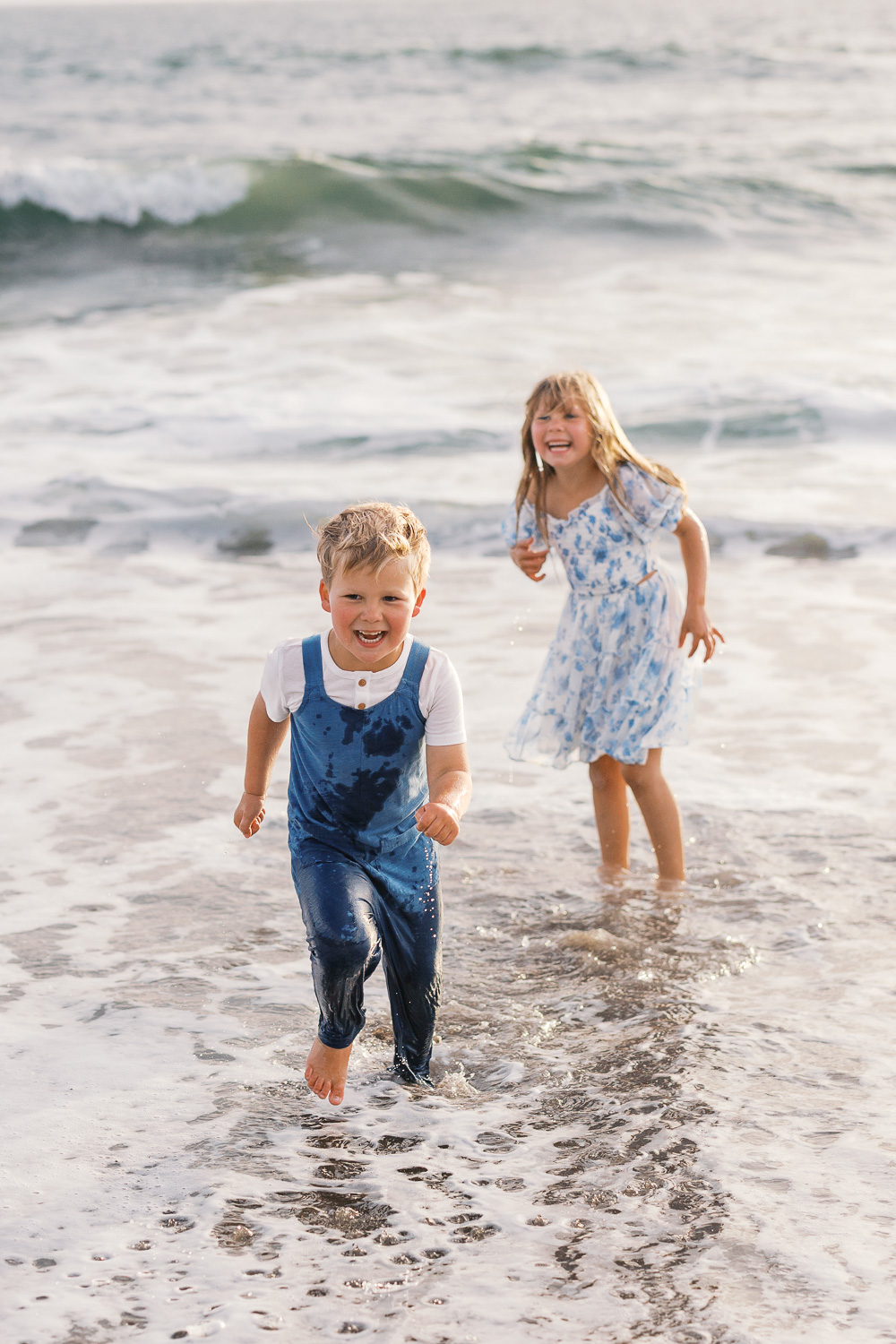 two young children play in ocean during bay area family photography session