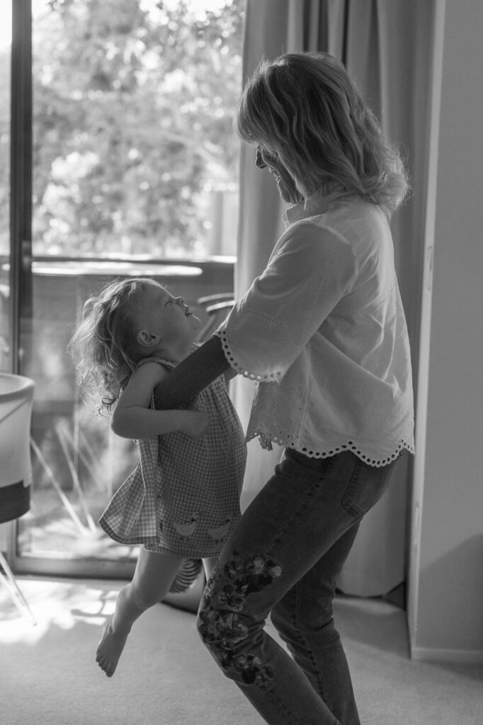 Grandma swings toddler big sister around during Alameda newborn photographer session 