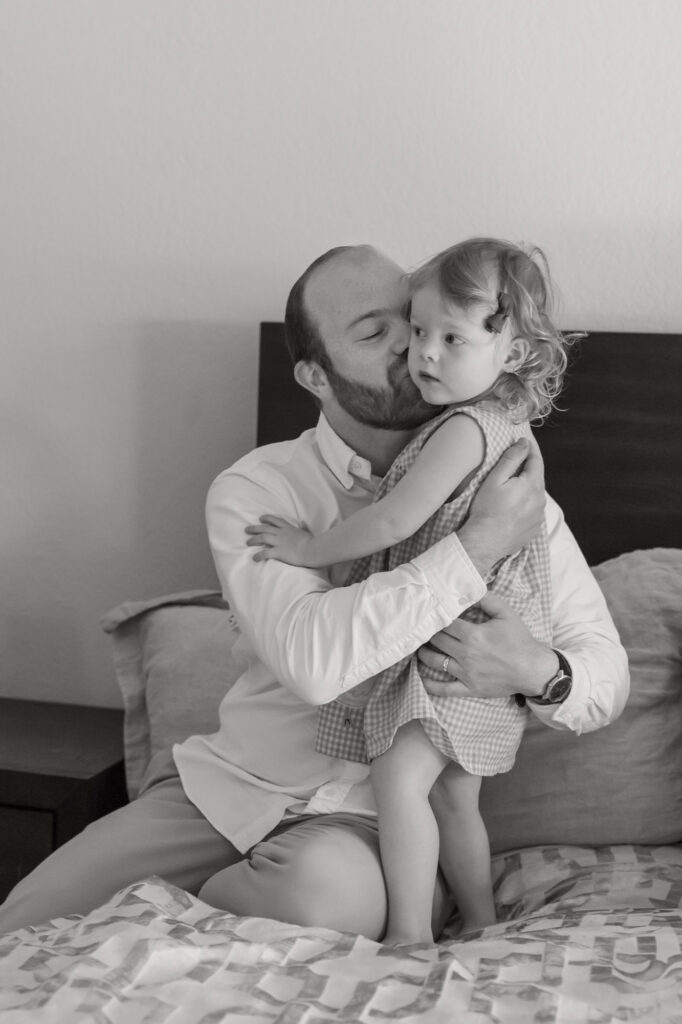 dad hugs toddler daughter during an Alameda photography session
