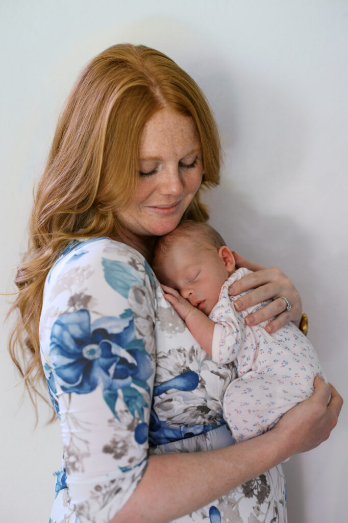 mom holds newborn baby girl during Alameda newborn photography session