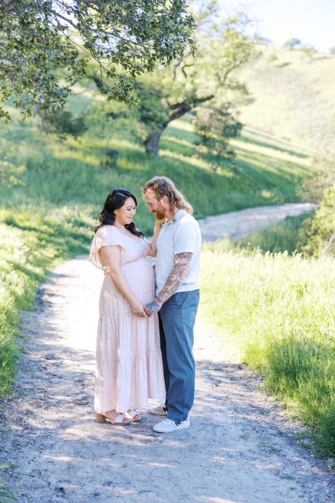 couple gaze on trail in Old Borges Ranch during Walnut Creek maternity session