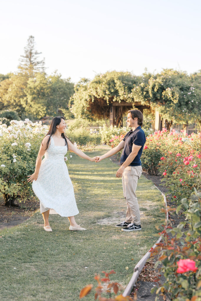 couple dance in the rows of roses at San Jose Rose Garden during golden hour