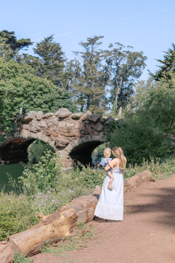 Mom shows toddler daughter the ducks and geese at Golden Gate Park