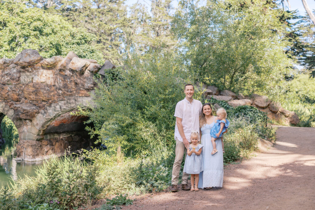 family of four poses during a Golden Gate Park family photography session in San Francisco