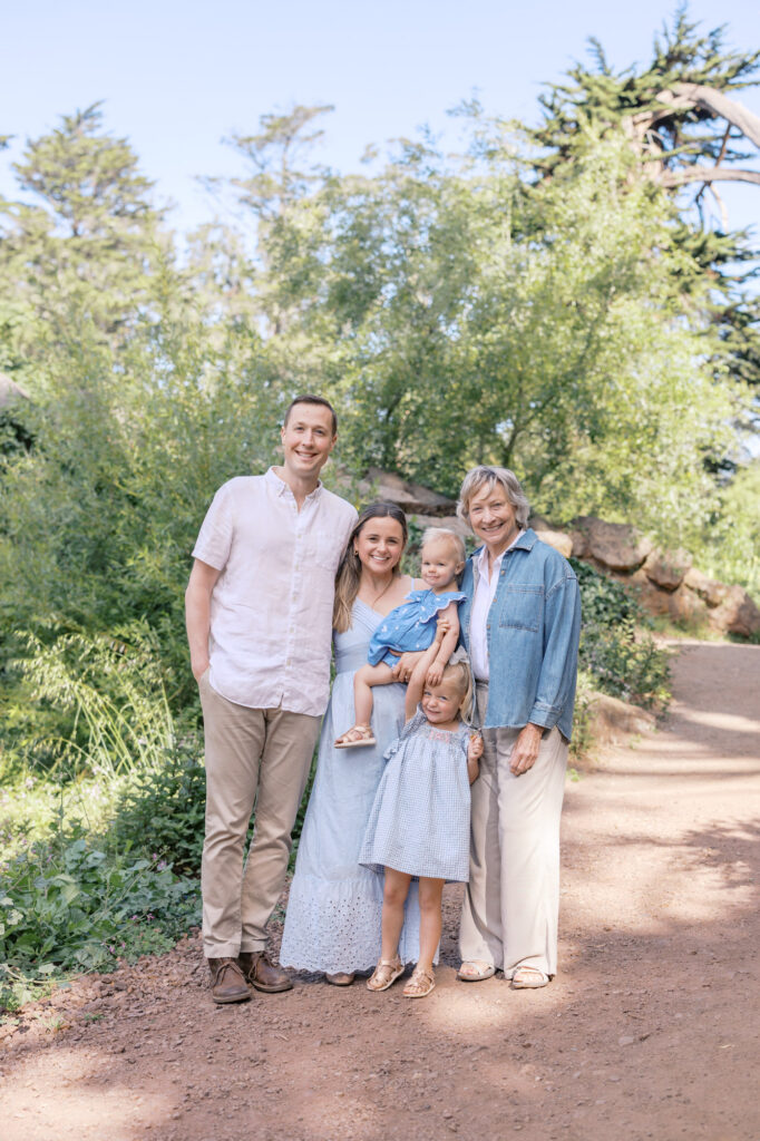 family of four poses for photos with grandma during their Golden Gate Park family photography session