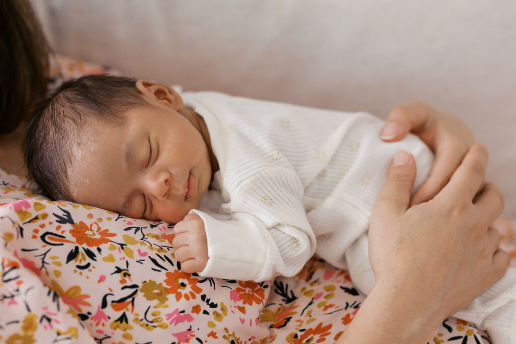 one month old baby boy lays on moms chest during San Mateo newborn photography session