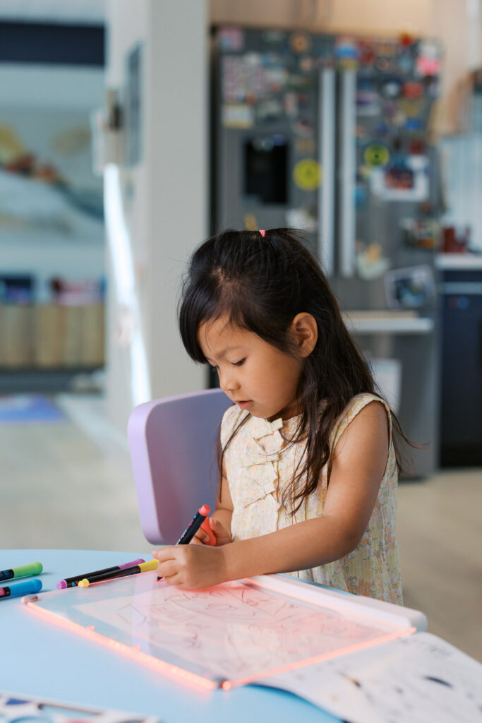 4 year old girl draws and does art independently during San Mateo photography session