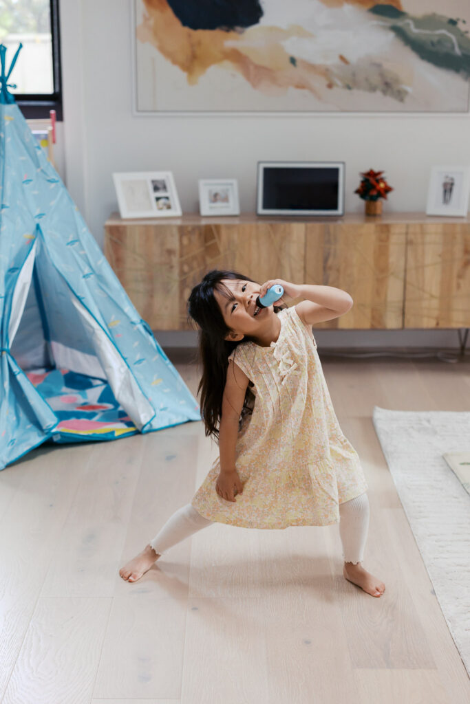 Toddler girl sings and performs in her home in San Mateo