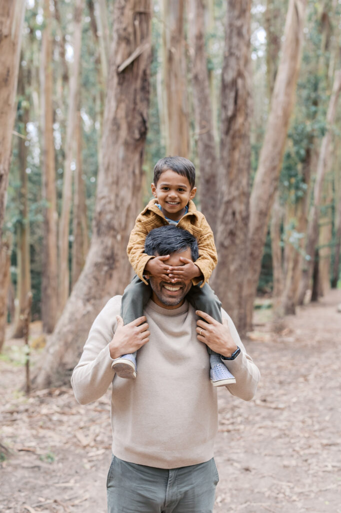 toddler hides Dad's eyes during maternity photography session in Presidio