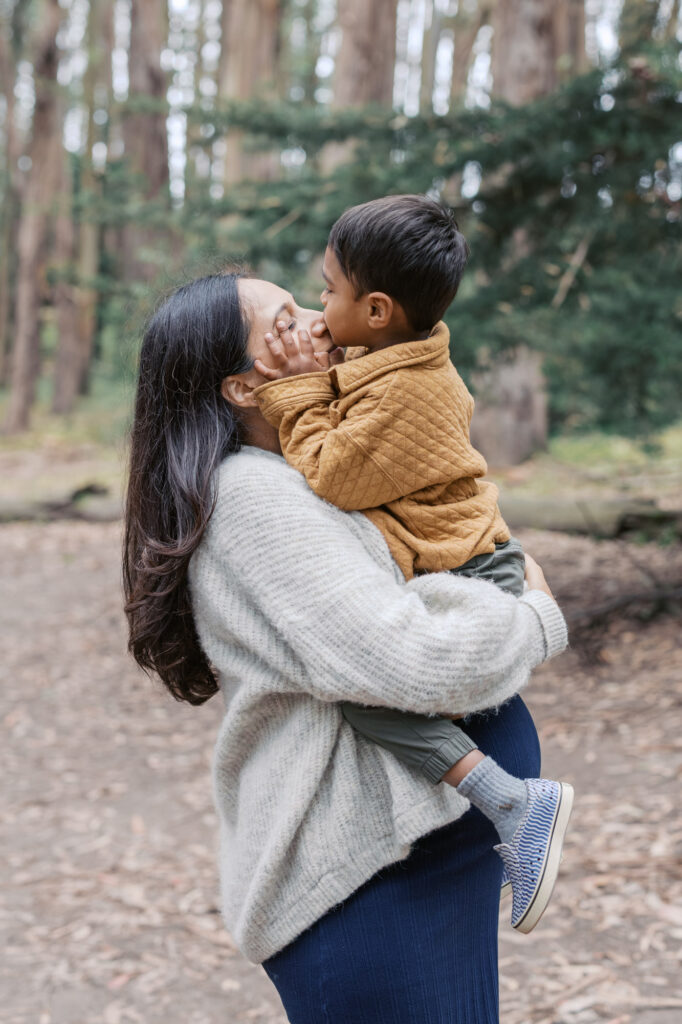 toddler kisses pregnant mom's nose during a Presidio maternity session in San Francisco