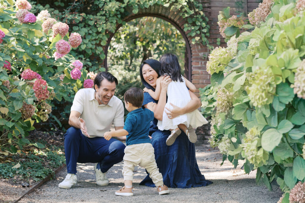 Family of four play amongst the hydrangeas at Filoli during their family photography session