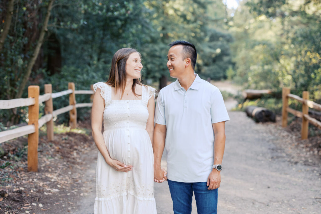 Expecting couple walk through Oakland Redwoods during their Bay Area maternity session