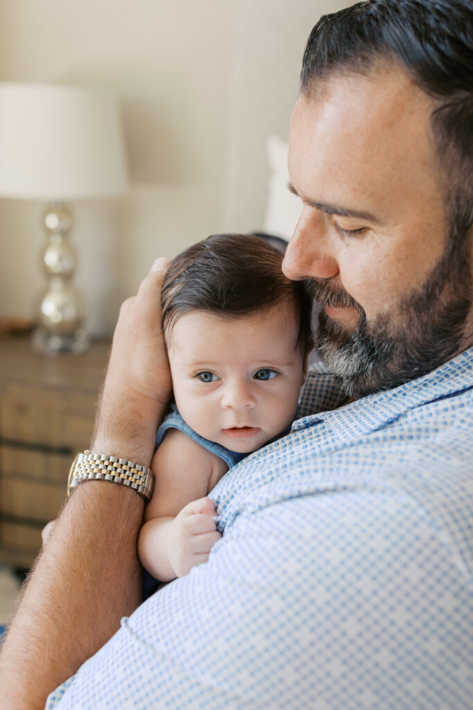 new dad holds 2 month old boy during Redwood City newborn photography session