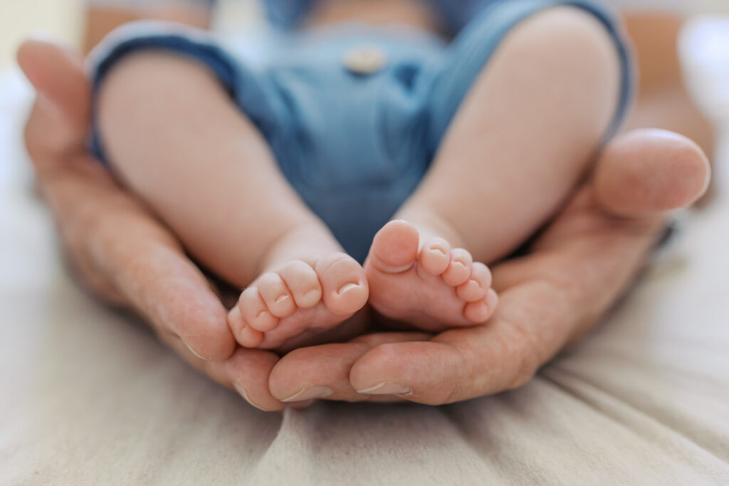 detail shot of 2 month old baby toes in parents hands during Redwood City newborn session
