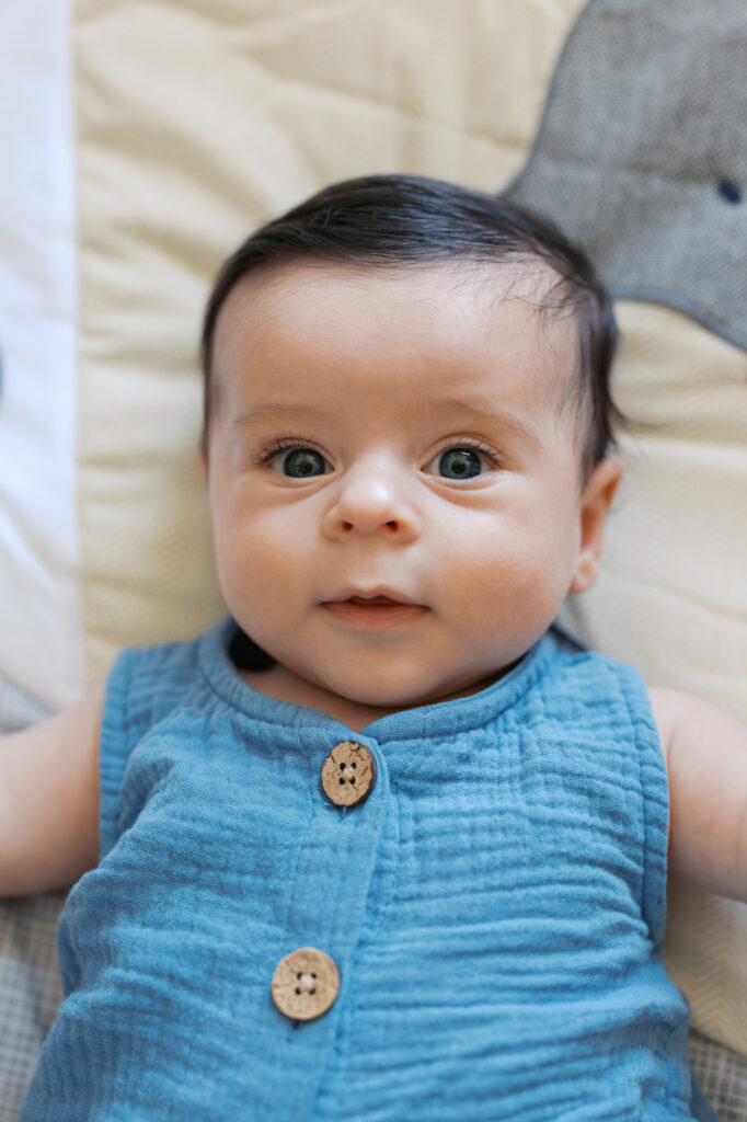 2 month old baby boy looks at camera during his newborn photography session in Redwood City