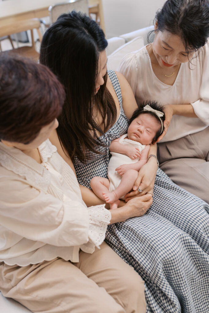 new mom and both grandmothers holding newborn in Santa Clara