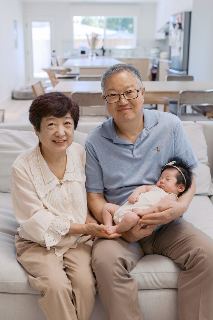 grandparents hold newborn baby girl during in home photography session in Santa Clara