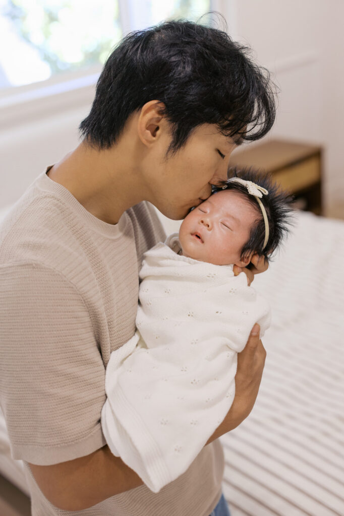 new dad kisses newborns forehead during Santa Clara newborn session
