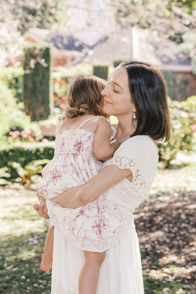 expecting mother holds her toddler in Filoli gardens during her Bay Area maternity session
